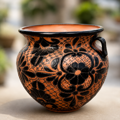 Ceramic vase with black floral patterns on a blurred background